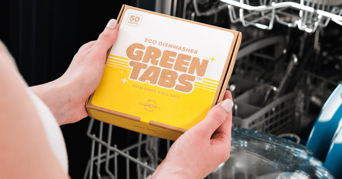 dishwasher detergent pack held beside diswasher