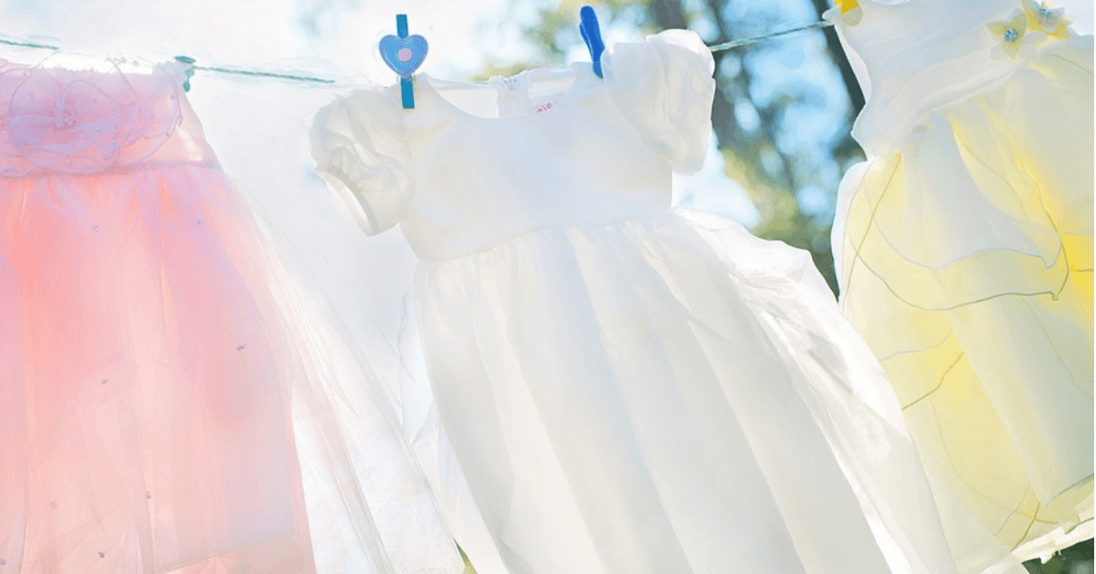 baby clothes on washing line after being washed with the best laundry detergent