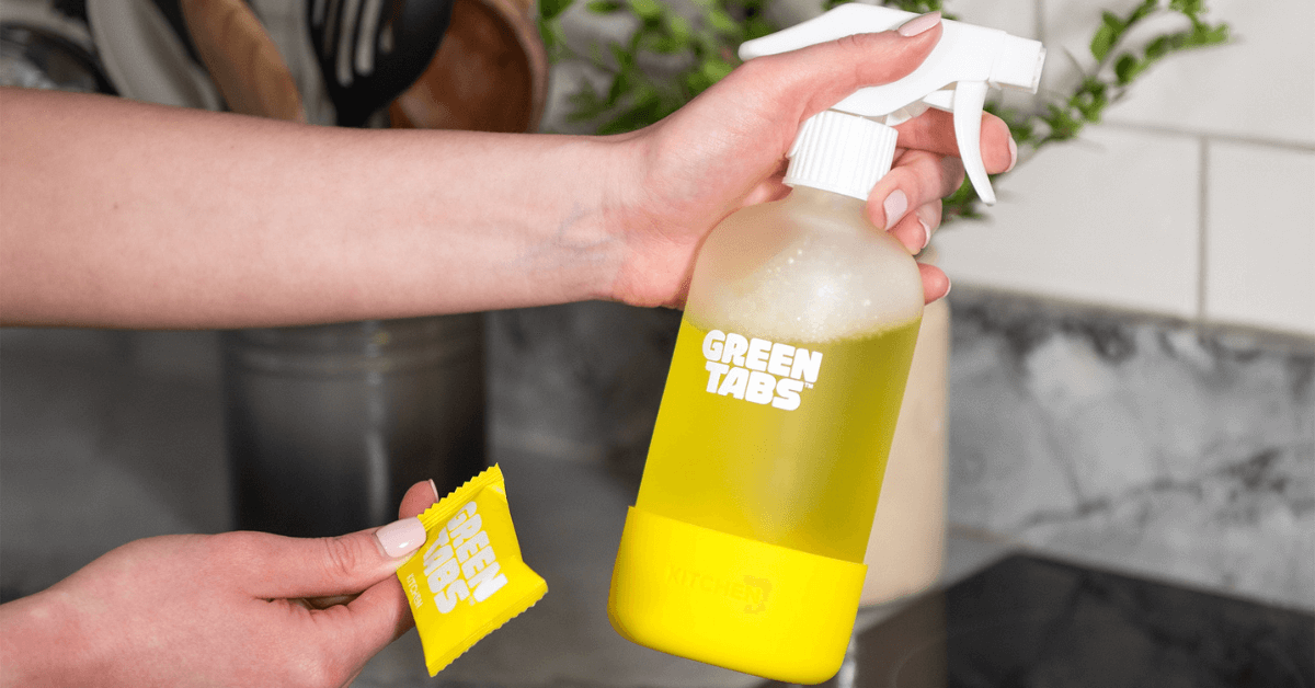 eco friendly kitchen spray greentabs bottle and refill tablet being held in hand