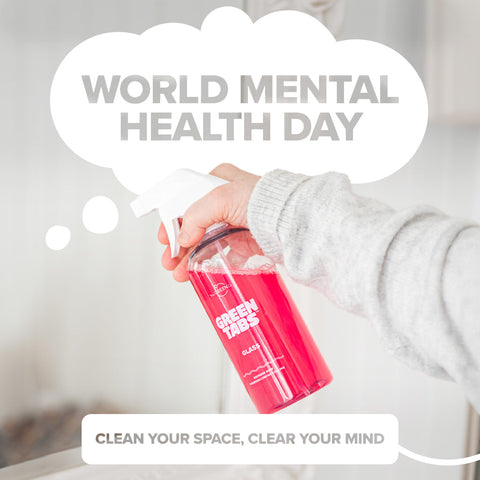 World Mental Health Day, Hand holding a GreenTabs forever bottle with the Glass cleaner to clean a mirror