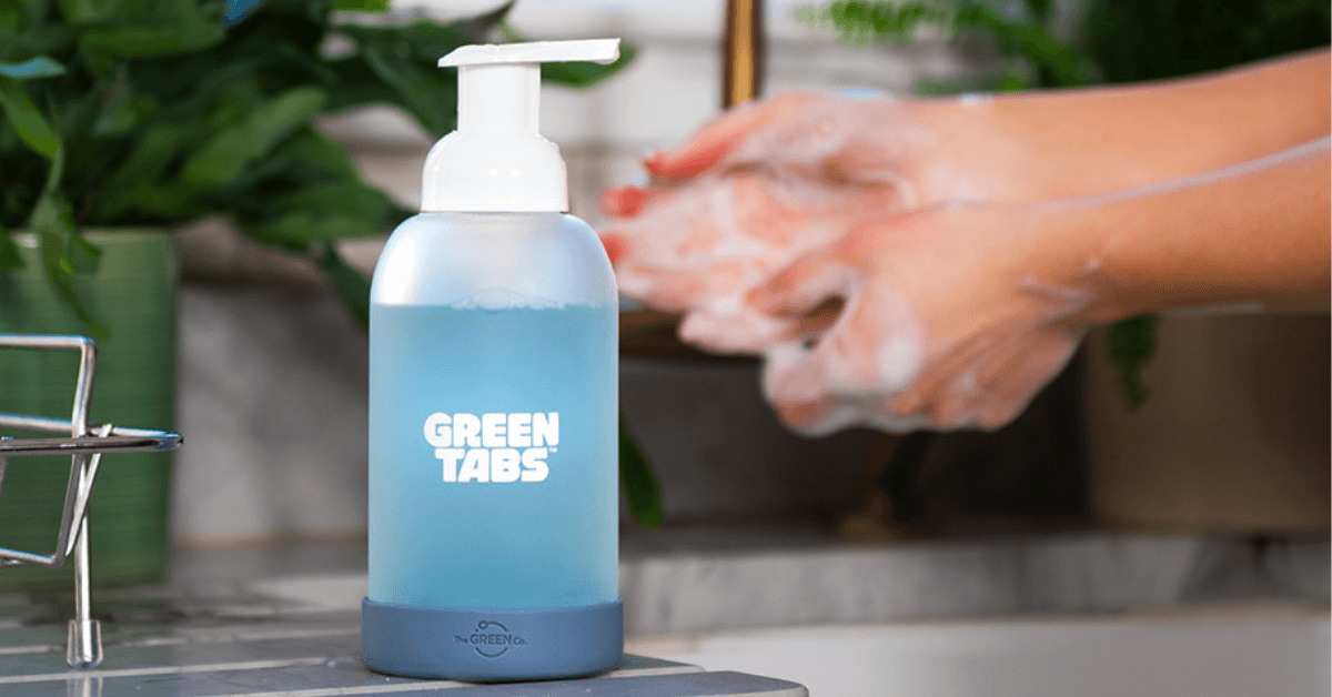 foaming hand soap greentabs at kitchen sink with  foam washing hands in background