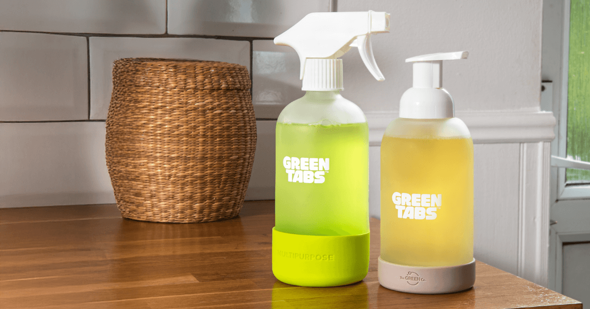 glass forever bottles from the green co for cleaning spray and foaming hand soap sitting on counter