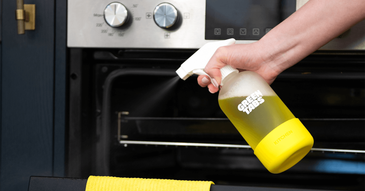 kitchen degreaser greentabs spraying on oven to clean naturally without harsh chemicals