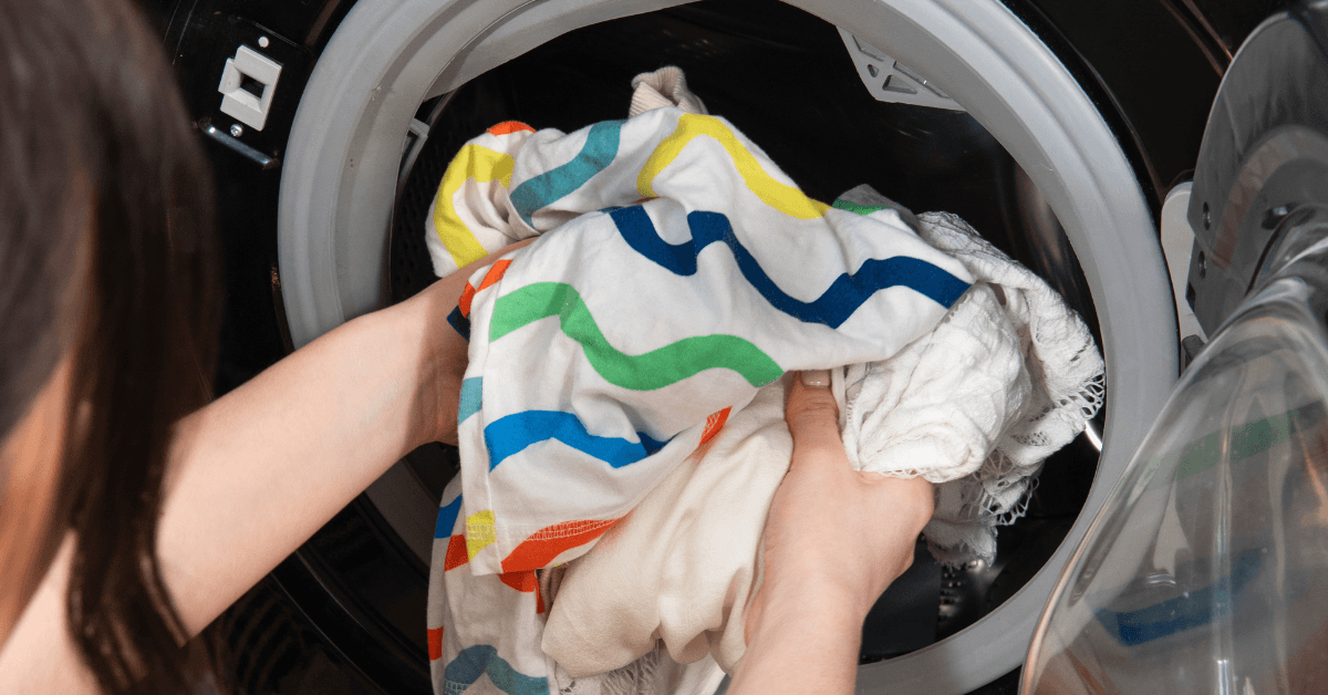 laundry being put into washing machine in hard water area