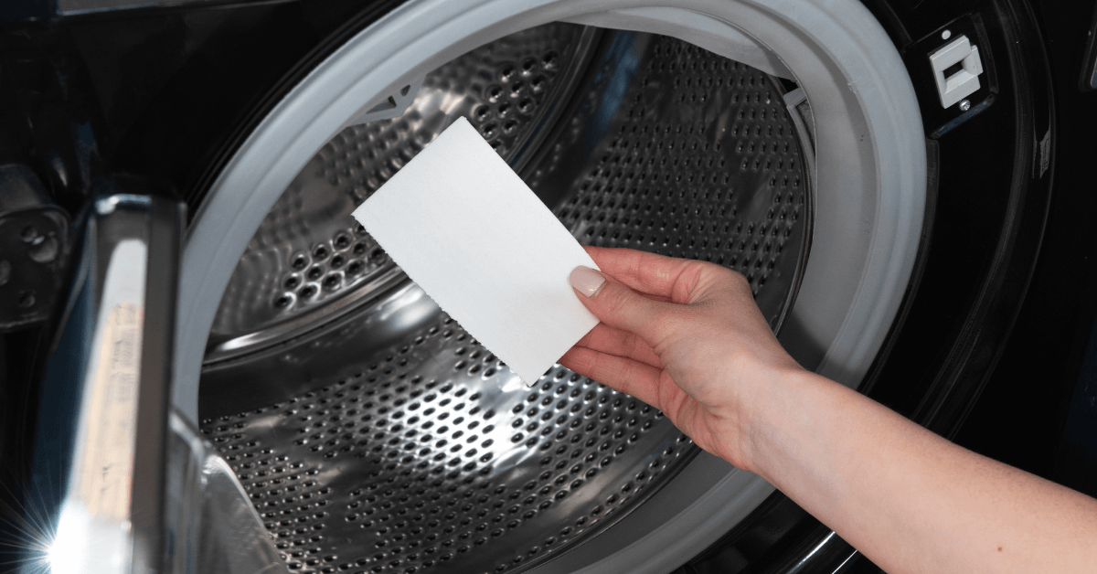 laundry detergent greensheet being placed into washing machine on cold setting