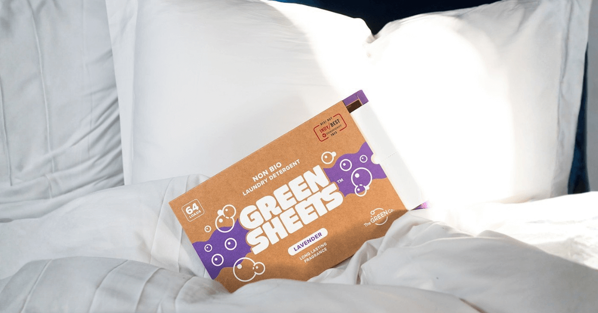 pack of lavender laundry detergent greensheets sat on white bed sheets ready to wash