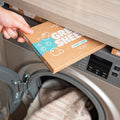 The Green Company fresh linen hypoallergenic clothes detergent strips being put away above the washing machine