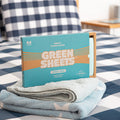 Blue Fresh Linen Fabric conditioner GreenSheets on top of a towel and sitting on a bed