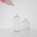 Gif video that shows a hand dropping in a Glass Cleaner GreenTab into a forever bottle infront of white backdrop, Gif showcasing how GreenTab dissolves